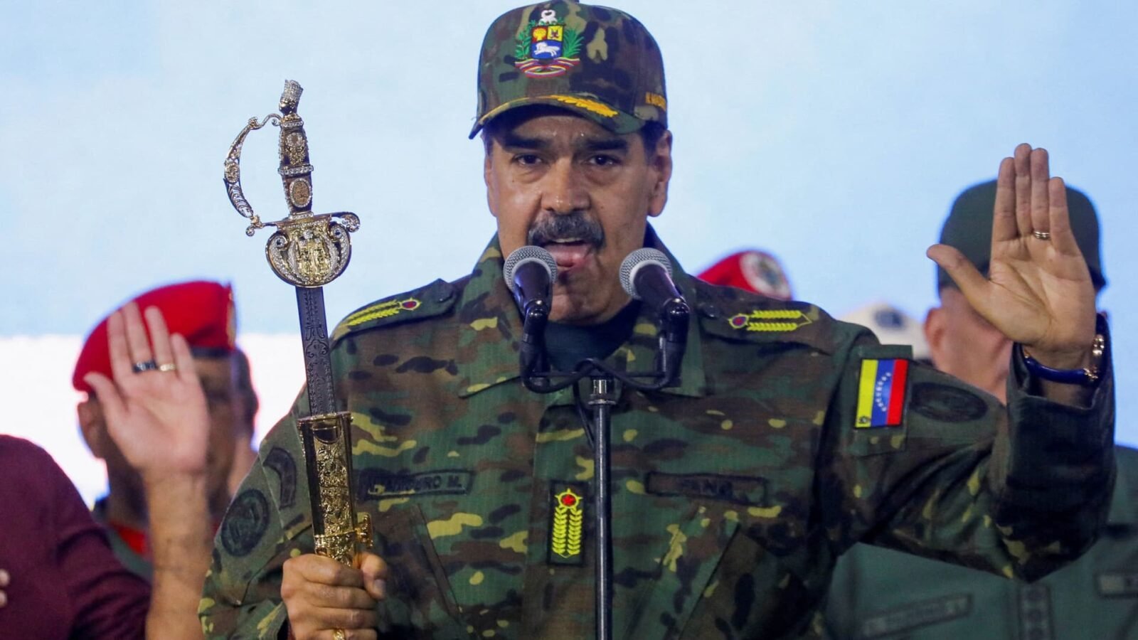 Venezuelan President Nicolas Maduro holds Simon Bolivar's sword during a rally at Fort Tiuna military base in Caracas, Venezuela, on November 25, 2025.