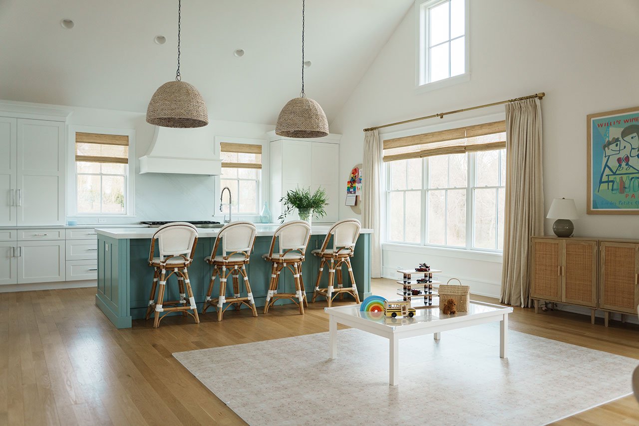 Ray Chen, founder of TWOPAGES, standing in a room with elegant custom window treatments