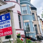 A balanced scale with a house on one side and a dollar sign on the other, symbolizing the shifting equilibrium in the real estate market.