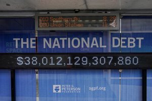 A visual representation of the U.S. national debt, possibly with a graph showing rising interest payments or a pile of money.