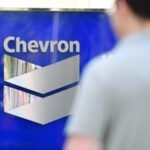 Chevron Corporation headquarters signage in Houston, Texas, symbolizing the company's cautious stance on Venezuelan oil investments.