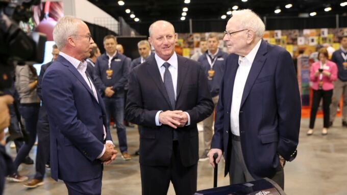 Warren Buffett and Greg Abel walking through the Berkshire Hathaway Annual Shareholders Meeting in Omaha, Nebraska