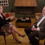 Warren Buffett speaking at the Berkshire Hathaway Annual Shareholders Meeting, offering wisdom and insights.