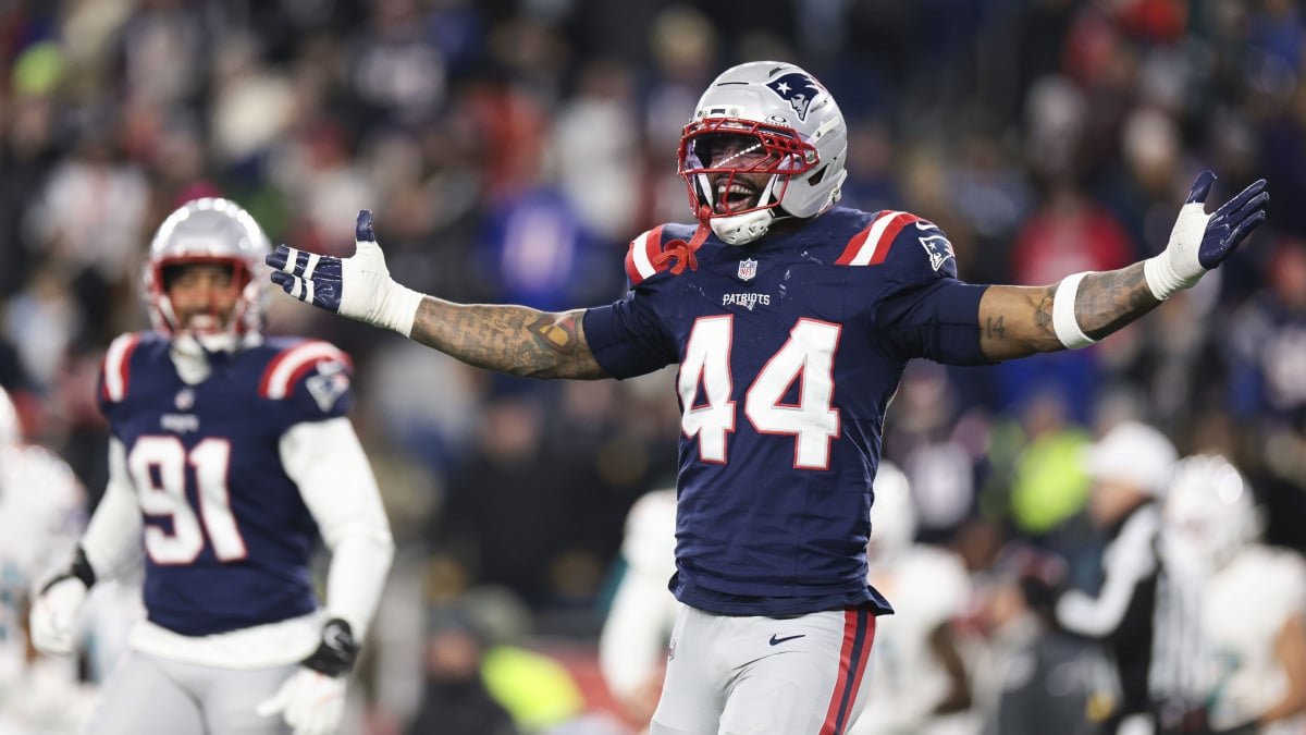 Los Angeles Chargers and New England Patriots players competing in an NFL playoff game