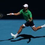 Novak Djokovic and Lorenzo Musetti on court during a tense Australian Open quarter-final match.