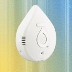 Various smart water leak detectors strategically placed in a modern home setting near appliances and water sources.