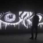 Waterlight Graffiti installation showing a wall of LED lights illuminated by water, creating ephemeral designs.