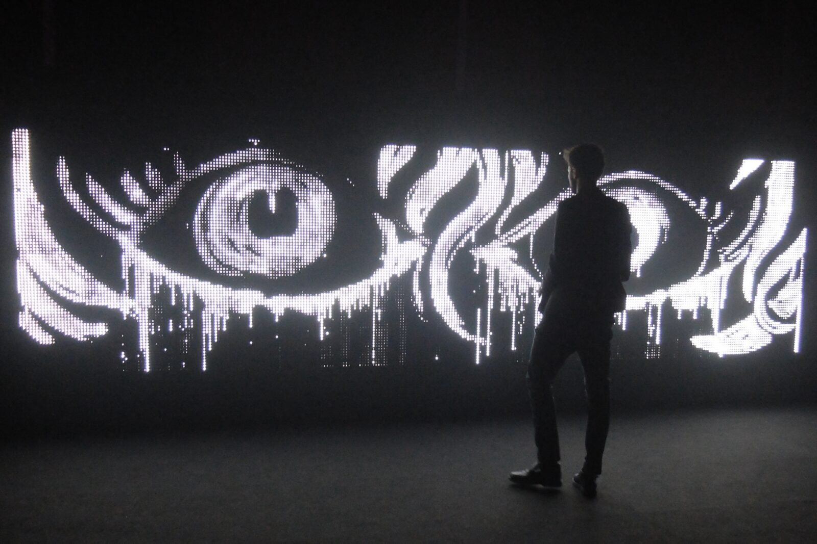 Waterlight Graffiti installation showing a wall of LED lights illuminated by water, creating ephemeral designs.