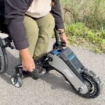 WheelMove attachment transforming a standard wheelchair into an electric one, shown at CES 2026
