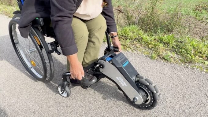 WheelMove attachment transforming a standard wheelchair into an electric one, shown at CES 2026