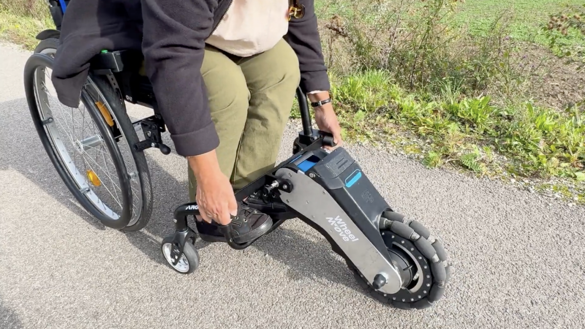WheelMove attachment transforming a standard wheelchair into an electric one, shown at CES 2026