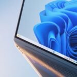 A close-up of a Windows 11 laptop displaying an error message or a shutdown screen, symbolizing the recent software issues.