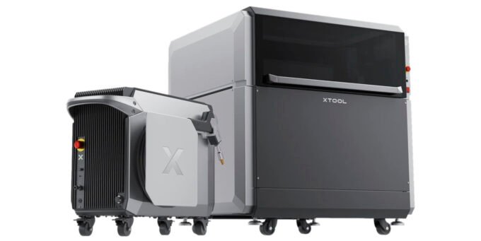 The xTool MetalFab laser system cutting a Makey robot stencil from 1.5mm thick steel, producing a shower of sparks.