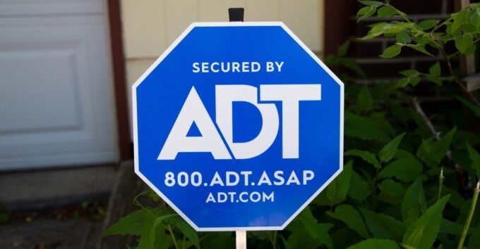 ADT logo alongside a graphic representing Wi-Fi signals detecting motion