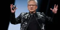 Nvidia CEO Jensen Huang speaking at a tech conference, with a backdrop of server racks or AI chips.