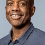 An abstract image depicting artificial intelligence algorithms interacting with scientific data, symbolizing global collaboration and discovery.