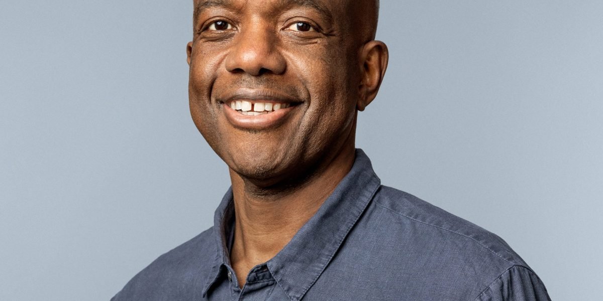 An abstract image depicting artificial intelligence algorithms interacting with scientific data, symbolizing global collaboration and discovery.