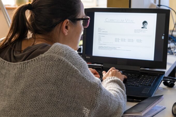 Navigating the AI Frontier: How to Excel in the Modern Job Interview 9 An abstract image depicting artificial intelligence influencing a job interview process, perhaps with a robot hand shaking a human hand, or AI symbols integrated into a resume.