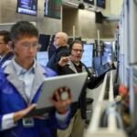 Wall Street's AI Reckoning: The 'Scare Trade' Spreads Beyond Tech 6 Wall Street traders reacting to market news, symbolizing AI's impact on financial markets.
