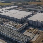 A futuristic image depicting AI data centers, symbolizing the intersection of technology and infrastructure, with a subtle nod to environmental impact.