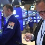 Stock market chart showing an upward trend with AI-related graphics in the background