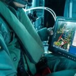 Airbus rugged tablet in a helicopter cockpit, displaying a drone control interface.
