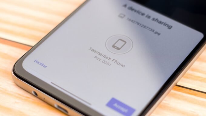 Android phone and iPhone exchanging files wirelessly, symbolizing AirDrop and Quick Share interoperability