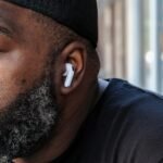 Apple AirPods: Your Definitive Guide to Unbeatable Deals Right Now 2 An Apple AirPods 4 earbud resting on a surface, highlighting its sleek design and wireless capabilities.