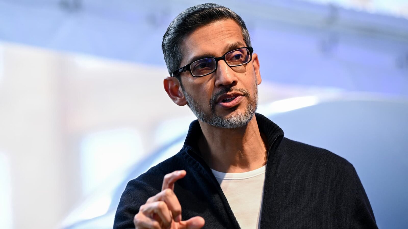 Google CEO Sundar Pichai gestures during Google's annual I/O developers conference, symbolizing Alphabet's focus on AI.