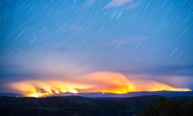 Illustration of a solar eclipse with zodiac symbols for Aquarius, Leo, and Scorpio, representing cosmic impact.