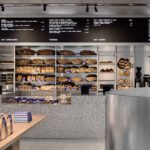 Baker Bleu: Crafting a Sensory Masterpiece in Melbourne's Bakery Scene 6 Interior view of Baker Bleu bakery in Cremorne, showcasing its industrial-intimate design with artisanal bread displayed.