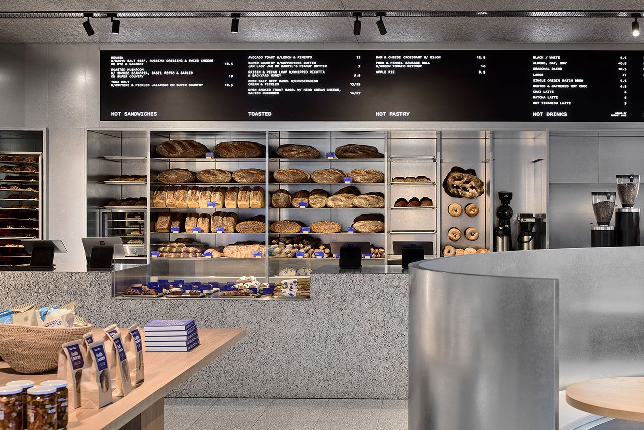 Baker Bleu: Crafting a Sensory Masterpiece in Melbourne's Bakery Scene 3 Interior view of Baker Bleu bakery in Cremorne, showcasing its industrial-intimate design with artisanal bread displayed.