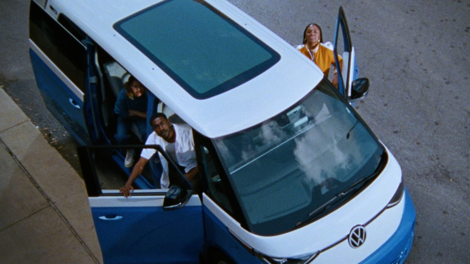 A football field with a car logo subtly integrated into the background, symbolizing the automotive industry's presence (or lack thereof) at the Super Bowl.