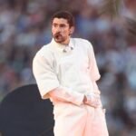 Bad Bunny performing energetically on stage during the Super Bowl halftime show.