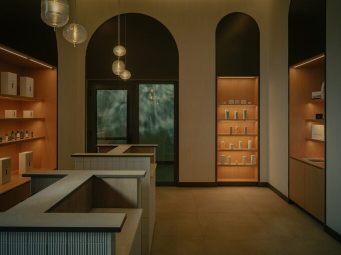 Exterior view of BASIN Glacial Waters thermal spa at Fairmont Chateau Lake Louise, showing arched windows and glacial backdrop.