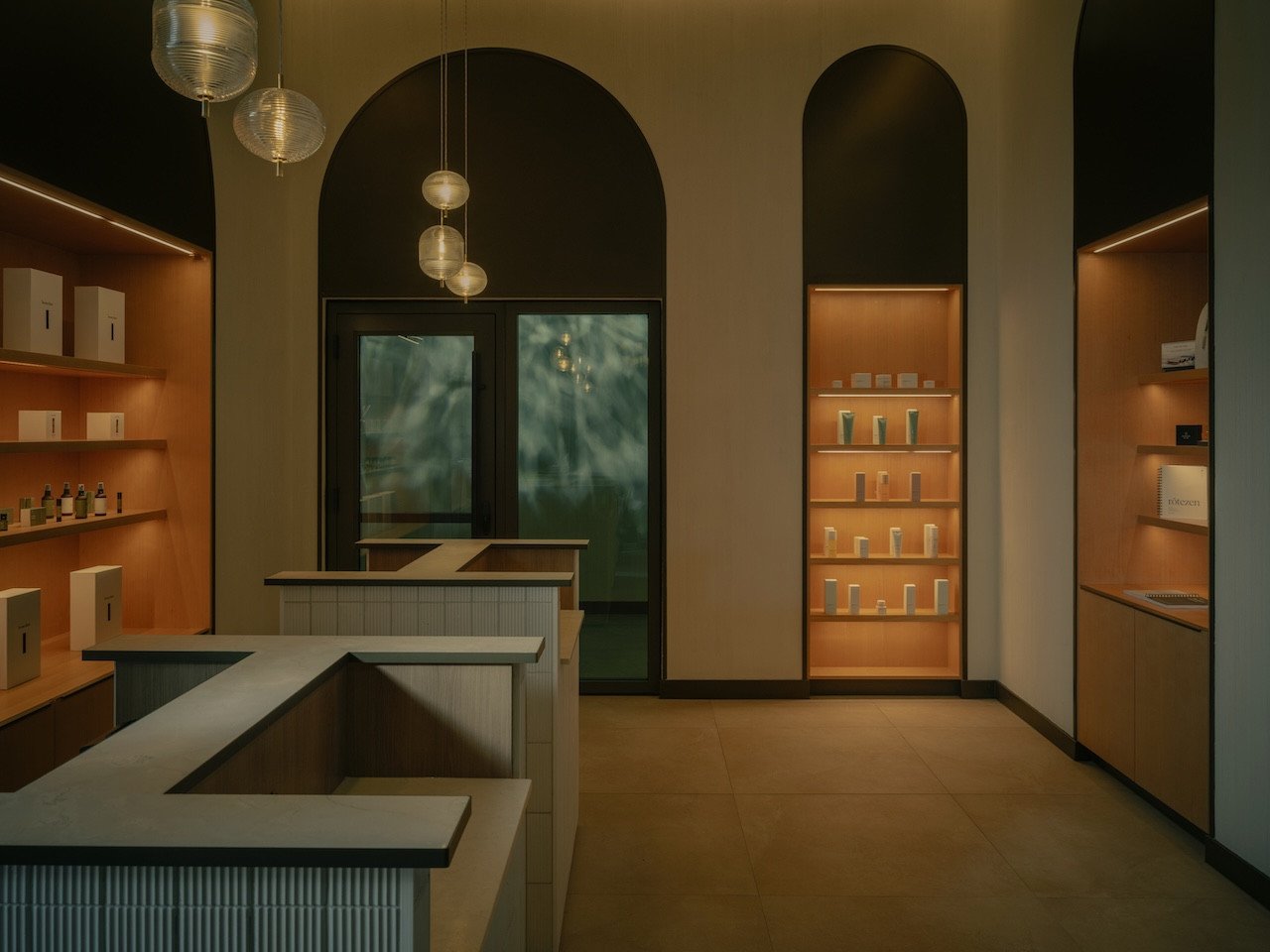 Where Glacier Meets Grace: Matteo Thun's BASIN Spa Redefines Alpine Wellness at Lake Louise 3 Exterior view of BASIN Glacial Waters thermal spa at Fairmont Chateau Lake Louise, showing arched windows and glacial backdrop.