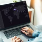 A secure internet connection represented by a shield icon over a globe, with a VPN server protecting user data.