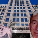 Demonstrators hold a "Save The Post" sign next to a cutout image of Jeff Bezos during a rally outside The Washington Post headquarters in Washington, DC.