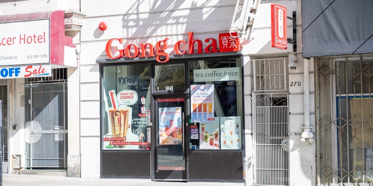 A Bubble Bliss boba tea store sign positioned closely to a Starbucks coffee shop, illustrating a strategic co-location business model.