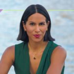 A woman in her late 30s, an athlete, looking determined, possibly lifting weights or rucking, representing strength and resilience in the face of an unexpected health diagnosis.