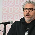 Wasserman's Shock Sale: Epstein Files Fallout Forces Talent Mogul's Hand 2 Casey Wasserman speaking at an event, with the Wasserman Media Group logo in the background.