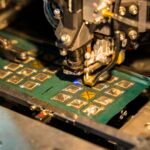 A robotic machine manufacturing a semiconductor chip, displayed for investors at an investment summit.