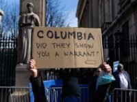 Protesters holding anti-ICE signs outside Columbia University after a student's detention.