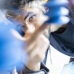 A graphic depicting a paradox: a thriving company with rising profits, yet showing a downward trend in employee numbers, possibly with AI symbols in the background.