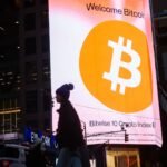 Bitcoin signage displayed prominently in Times Square, New York, amidst market volatility.