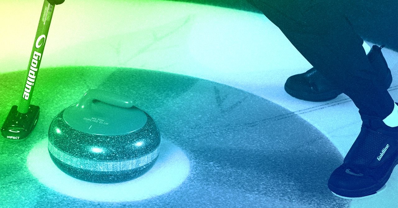 Close-up of a curling stone gliding on ice with a broom sweeping ahead, showcasing advanced sports technology.