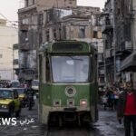 صورة لترام الرمل التاريخي في الإسكندرية، يظهر فيه خط السكك الحديدية وسط المدينة.