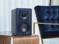 DALI KUPID Hi-Fi speakers in a modern home setting, showcasing their compact size and stylish design.