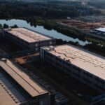 An illustration depicting data center servers with an overlay of a power grid or environmental elements, symbolizing the debate around their impact.