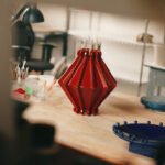 Joseph Sgambati III presenting his 'Take 5' design favorites, featuring colorful objects, ceramic art, and stylish seating.